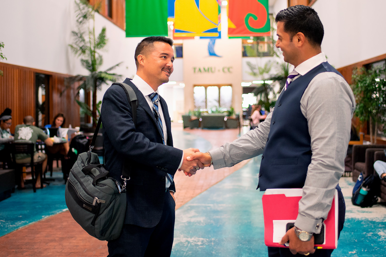 student shaking hands with professor
