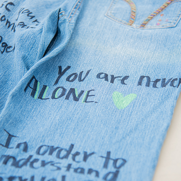 Jeans with the words written You are never alone