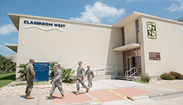 Outside of Classroom West, a white brick building on the TAMUCC campus