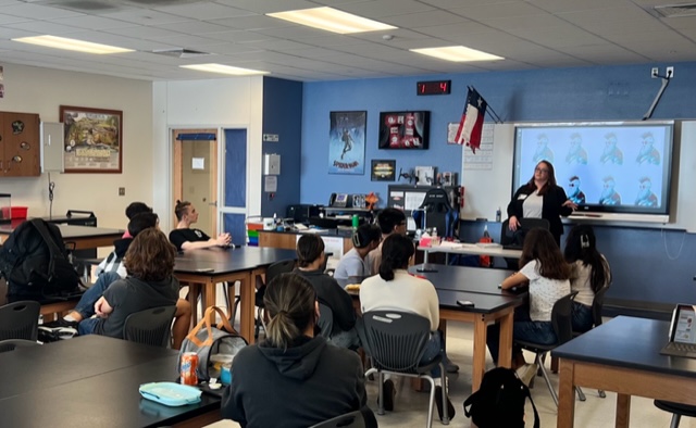 teacher speaking to a high school class