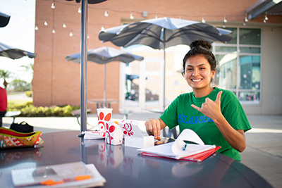 Student eating chicken from chick fil a