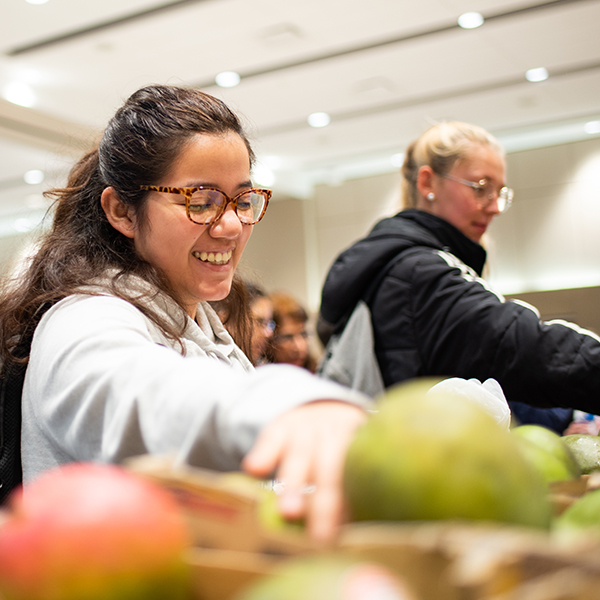 Student grabbing mangos at fresh food fridays