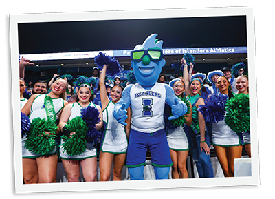 Izzy standing with Cheerleaders