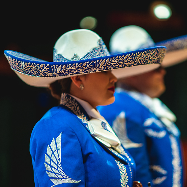 female mariachi standing on stage