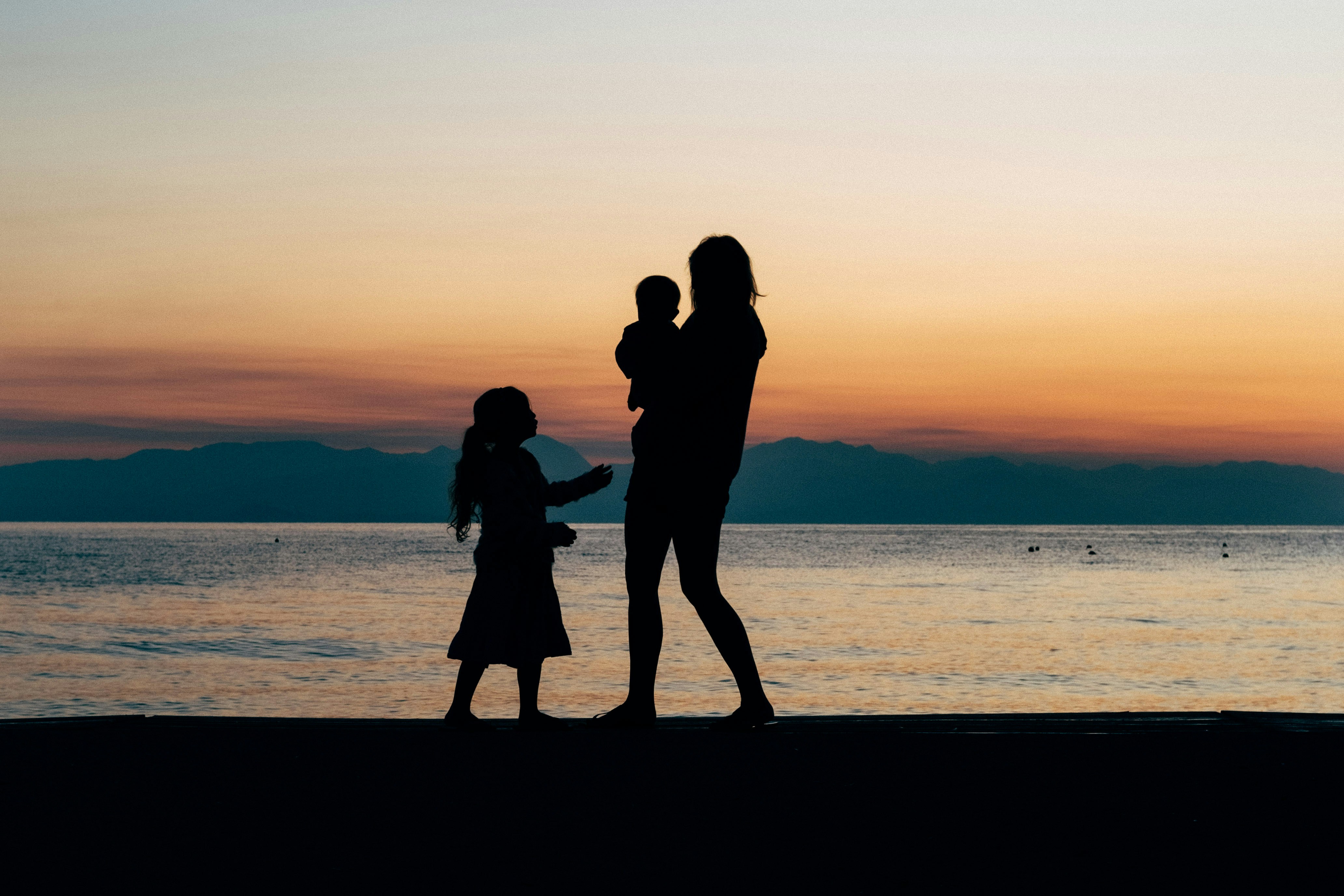 Image of a mother, child in the sun, beach