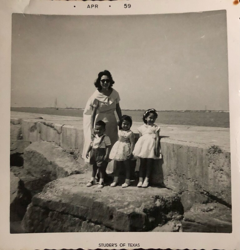 Marie Vasquez with her three oldest children, standing on the Corpus Christi seawall.