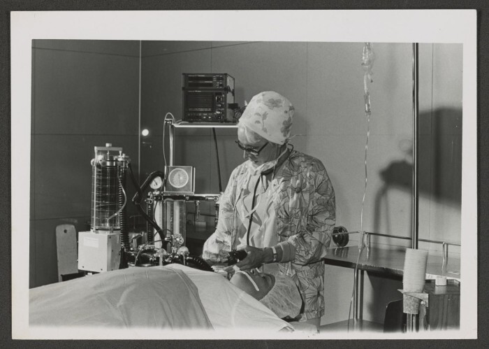 A woman doctor working on a patient.