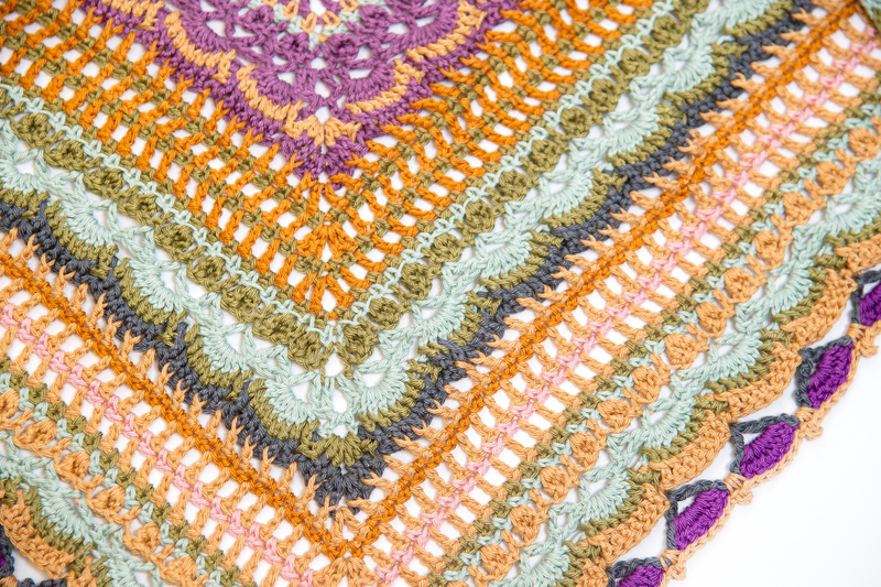 Close up of colorful crocheted shawl.