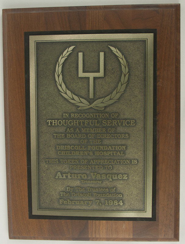 A plaque of Thoughtful Service from the Board of Directors of the Driscoll Foundation Children's Hospital to Arturo Vasquez.