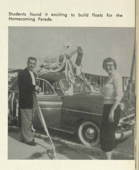 Two students with their homecoming float.  The caption states "Students found it exciting to build floats for the Homecoming Parade."