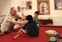Arturo Vasquez, "Popo,"  playing with Gabriel and Adrian on the family pool table. 