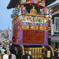 A decorated float with people in traditional attire at a Japanese festival.