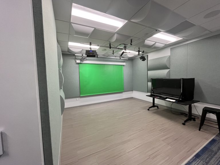 View of One Button Studios showing Lights, gree screen and microphones