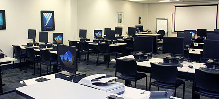 Computers, tables, and chairs inside the First Floor Computer Lab