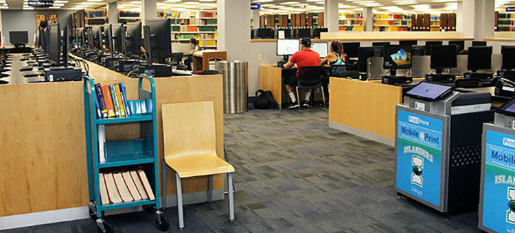 Computer stations and printers near Ask Us Desk