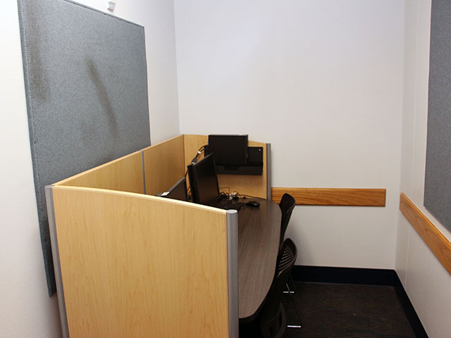 Interior of 1-2 person study room with study carrel, two computers, and two chairs.