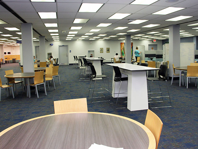 Study room in I-Create Lab. Includes TV monitor with a table and four chairs