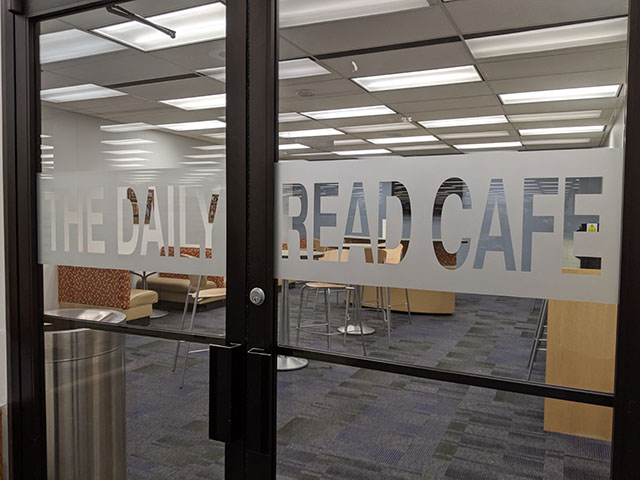 Double glass doorway entrance to Daily Read Cafe inside the library