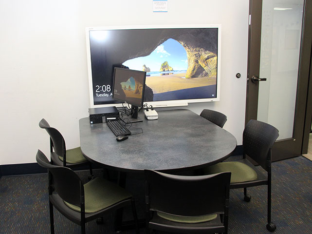 I-Create Lab study room with a TV monitor, table, and four chairs