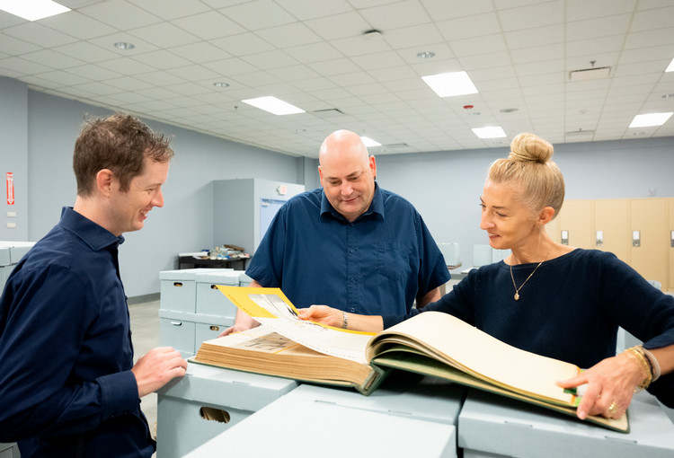 Three+archive+officials+looking+through+the+donated+archives