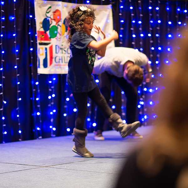 Little girl dances on stage